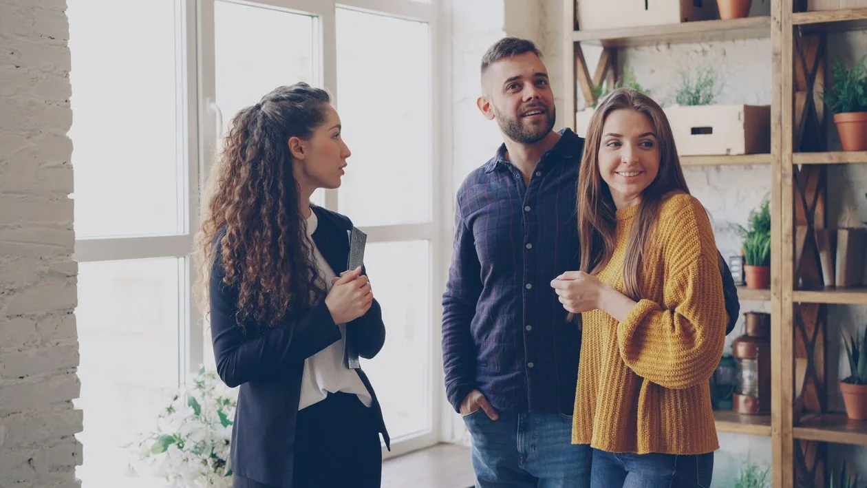 A real estate agent showing an apartment to a couple.