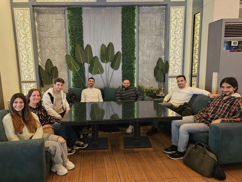 The OOB Consulting team together around a table.
